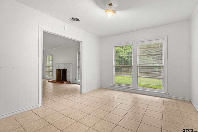 708 E Loftin St, Tyler, TX 75701 - spare room featuring a brick fireplace and light tile patterned floors