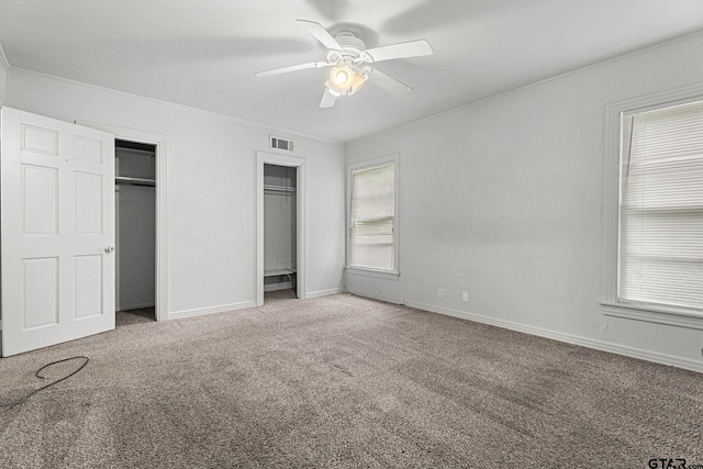 708 E Loftin St, Tyler, TX 75701 - unfurnished bedroom with multiple closets, carpet flooring, ornamental molding, and ceiling fan