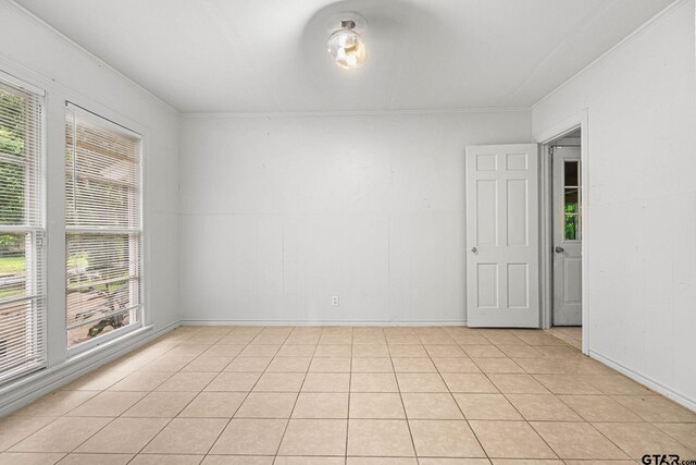 708 E Loftin St, Tyler, TX 75701 - unfurnished room with crown molding and light tile patterned floors
