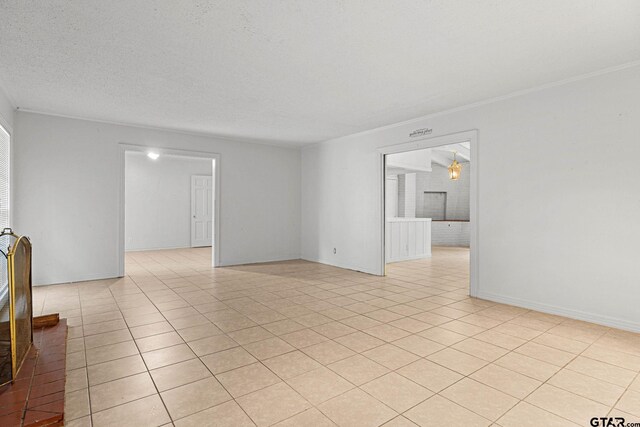 708 E Loftin St, Tyler, TX 75701 - empty room featuring light tile patterned floors and ornamental molding
