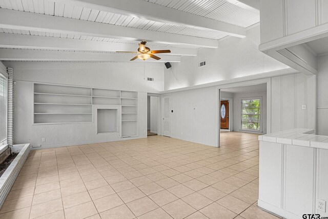 708 E Loftin St, Tyler, TX 75701 - unfurnished living room with built in shelves, ceiling fan, and light tile patterned flooring