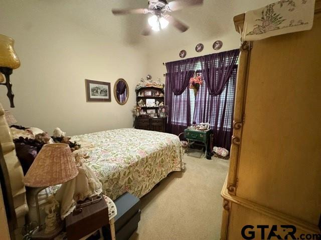 bedroom featuring carpet and a ceiling fan