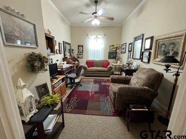 living area with a ceiling fan, carpet, and ornamental molding