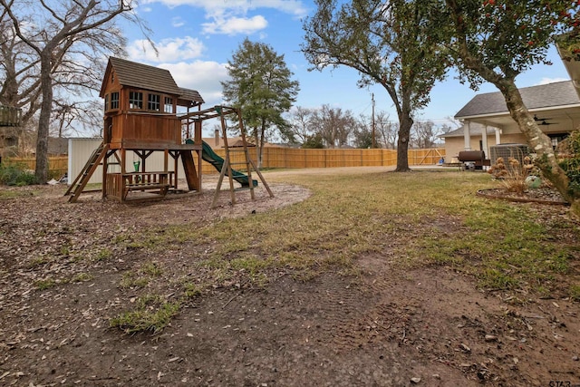 view of playground with a yard and fence