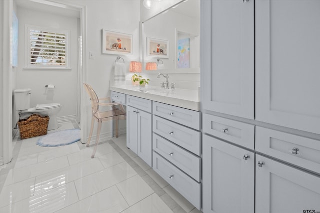 full bath featuring tile patterned flooring, baseboards, vanity, and toilet