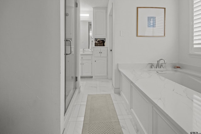 full bathroom with a stall shower and vanity