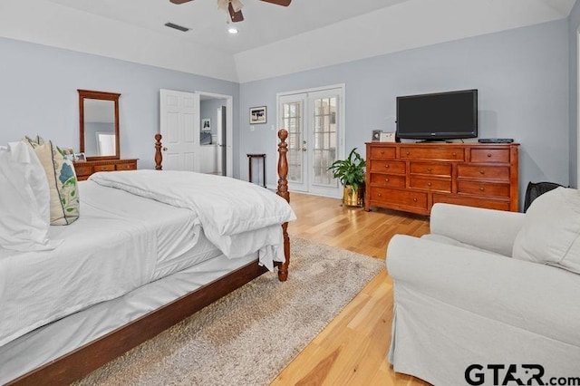 bedroom featuring visible vents, light wood-style flooring, vaulted ceiling, french doors, and recessed lighting