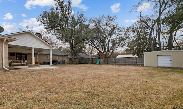 view of yard featuring ceiling fan, a patio, a fenced backyard, a fire pit, and central AC