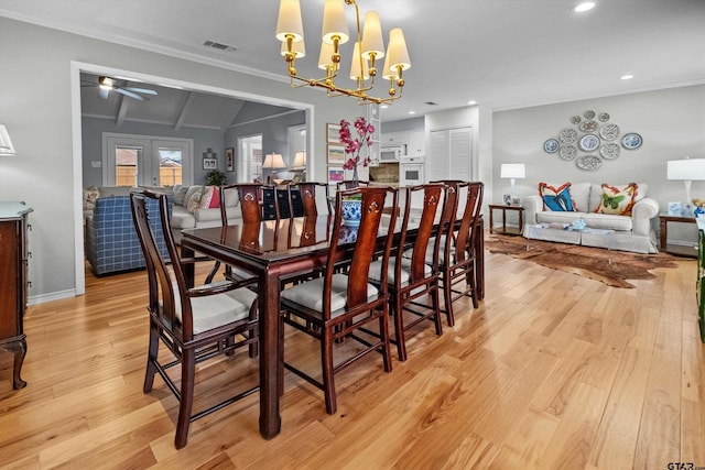 dining space with ornamental molding, french doors, light wood-type flooring, and visible vents