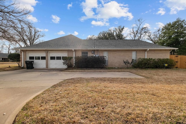 view of property exterior with brick siding, a yard, concrete driveway, an attached garage, and fence