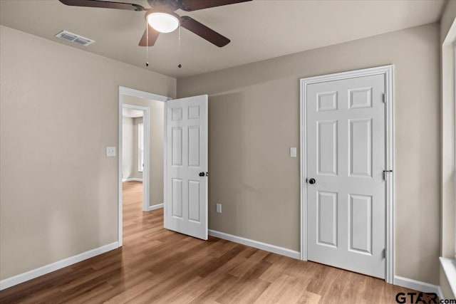 unfurnished bedroom featuring ceiling fan and light wood-type flooring