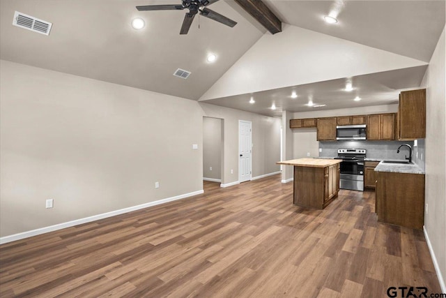 kitchen featuring appliances with stainless steel finishes, sink, dark hardwood / wood-style floors, and a center island