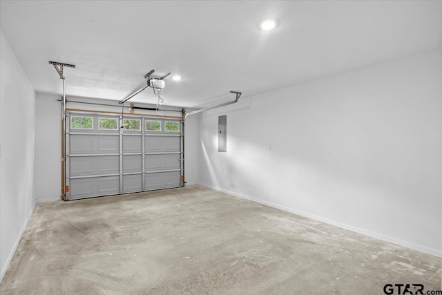 garage with a garage door opener and electric panel