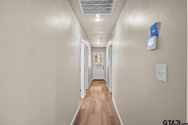 hallway with light wood-type flooring