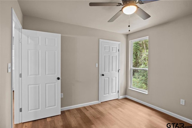 unfurnished bedroom with light hardwood / wood-style floors and ceiling fan