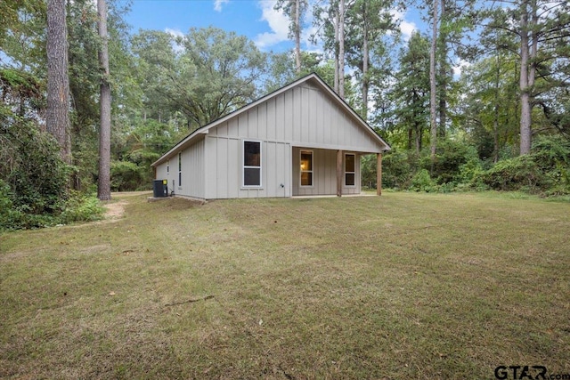 view of front of home with a front lawn and central air condition unit