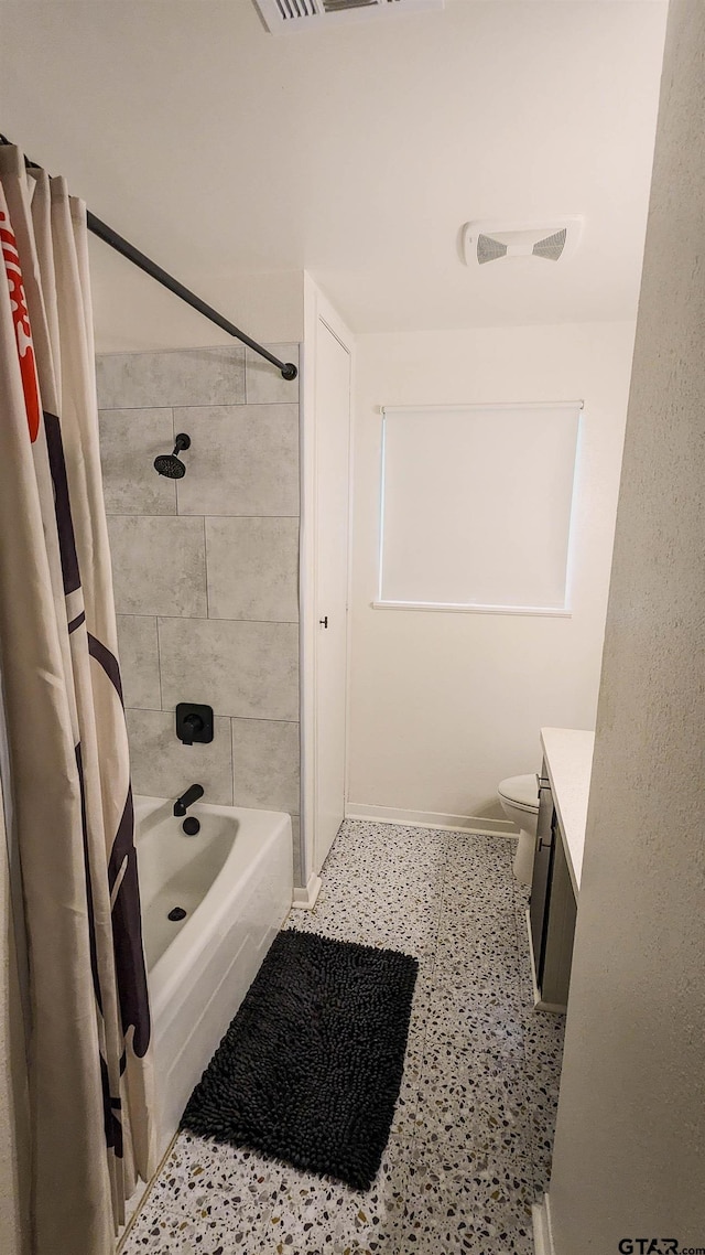 1418 E Dawson St, Tyler, TX 75701 - bathroom with vanity, shower / bathtub combination with curtain, and speckled floor