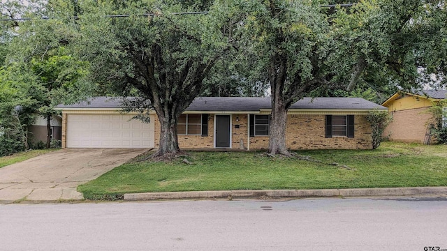 1418 E Dawson St, Tyler, TX 75701 - ranch-style home featuring an attached garage, concrete driveway, a front lawn, and brick siding