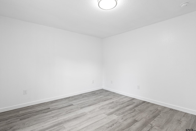 2807 Hendricks St, Gladewater, TX 75647 - empty room with wood finished floors and baseboards
