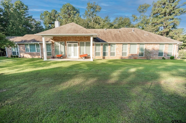 21585 Syrah Ln, Tyler, TX 75703 - back of property featuring a chimney, a lawn, a patio area, and brick siding