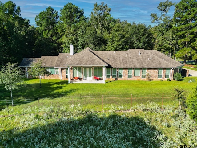 21585 Syrah Ln, Tyler, TX 75703 - back of house with a chimney, a yard, a patio area, and brick siding