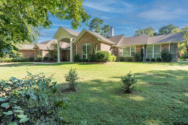 21585 Syrah Ln, Tyler, TX 75703 - view of front of property featuring brick siding, a chimney, a front yard, and roof with shingles