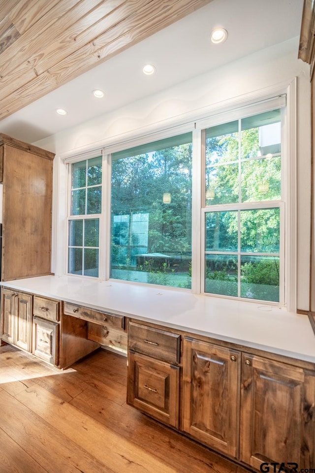 details featuring built in desk and wood-type flooring