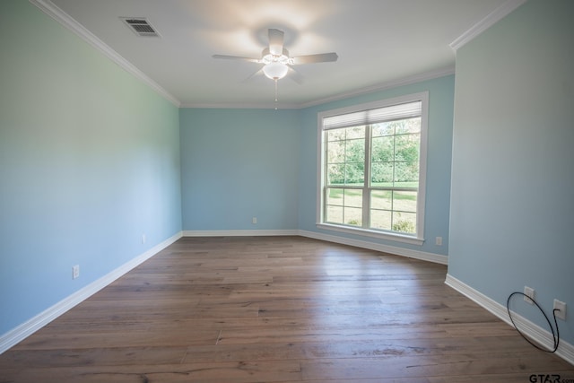 empty room with ceiling fan, dark hardwood / wood-style flooring, and ornamental molding