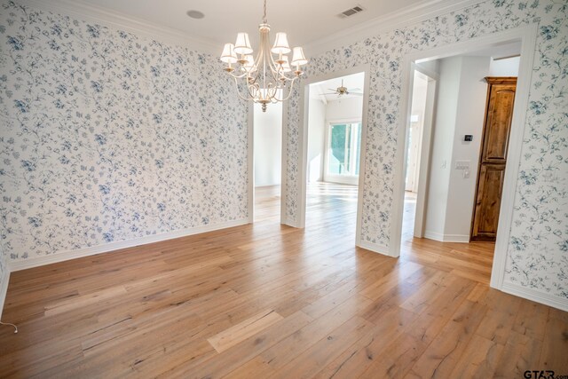 spare room featuring ornamental molding, light hardwood / wood-style floors, and ceiling fan with notable chandelier