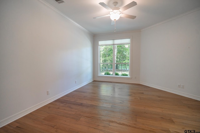 spare room featuring ornamental molding, hardwood / wood-style flooring, and ceiling fan