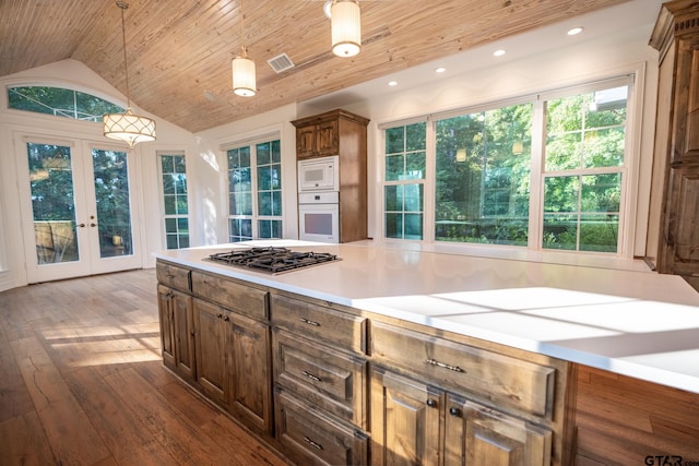 kitchen with french doors, pendant lighting, hardwood / wood-style flooring, white appliances, and lofted ceiling