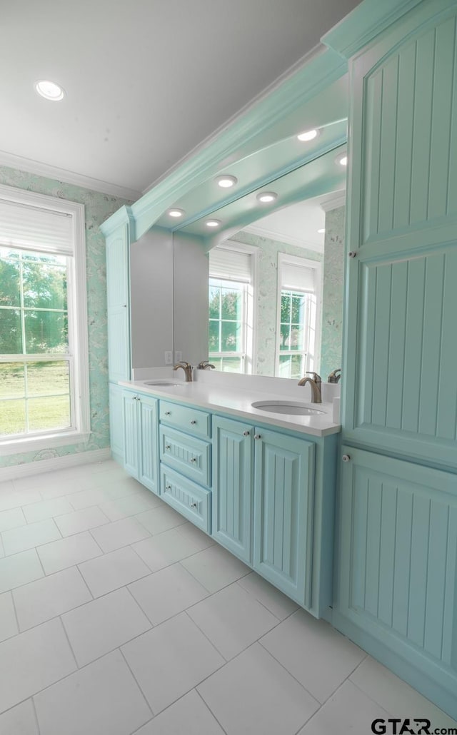 bathroom with ornamental molding, tile patterned flooring, a wealth of natural light, and vanity