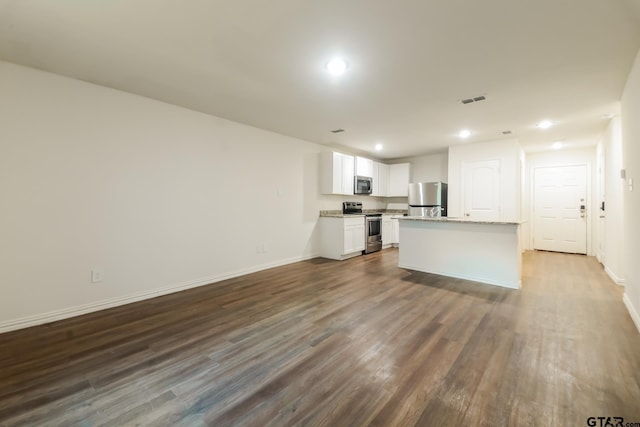 807 W Morris St, Tyler, TX 75702 - unfurnished living room featuring dark wood-style floors and recessed lighting