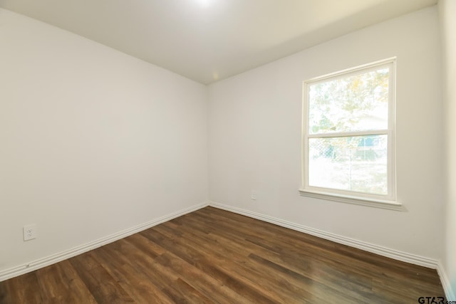 807 W Morris St, Tyler, TX 75702 - spare room featuring dark wood-style flooring and baseboards