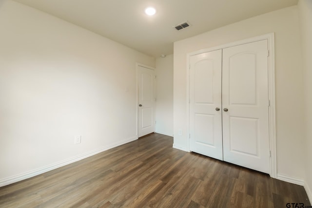 807 W Morris St, Tyler, TX 75702 - unfurnished bedroom featuring dark wood finished floors and a closet