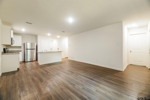 807 W Morris St, Tyler, TX 75702 - unfurnished living room with dark wood-type flooring and recessed lighting
