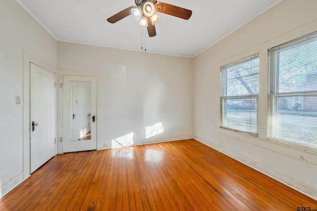 empty room with crown molding, ceiling fan, and light hardwood / wood-style flooring