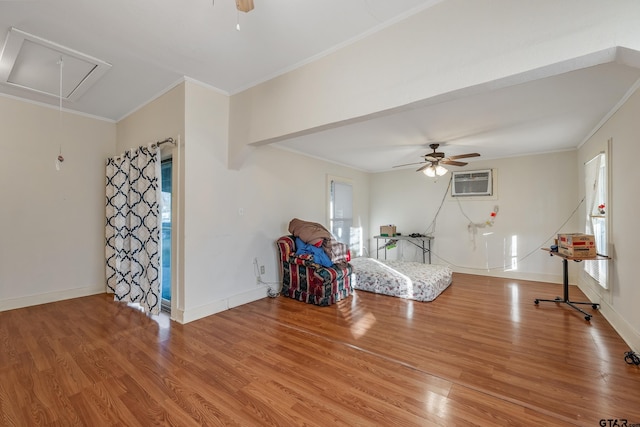 living area featuring crown molding, ceiling fan, a wall unit AC, and light hardwood / wood-style flooring