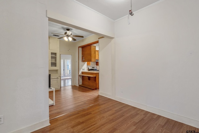 unfurnished living room with crown molding, light hardwood / wood-style flooring, and ceiling fan