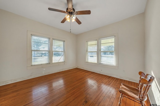 empty room with hardwood / wood-style flooring and ceiling fan