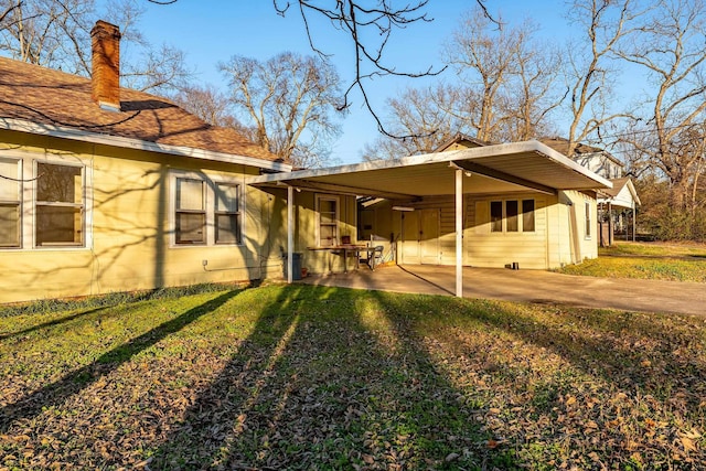 view of side of property with a yard and a carport