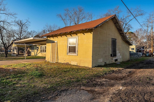 view of home's exterior with a carport