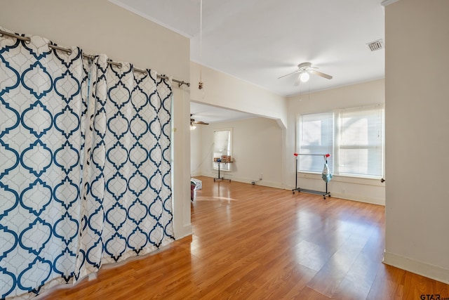 empty room with ceiling fan and light wood-type flooring