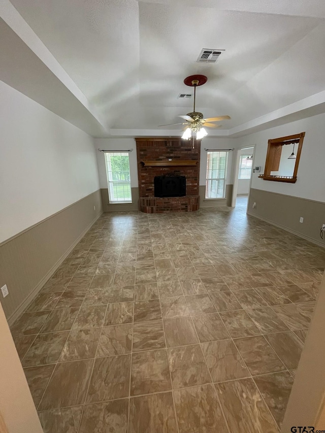 120 An County Road 4287, Palestine, TX 75803 - unfurnished living room featuring wainscoting, ceiling fan, a raised ceiling, and visible vents
