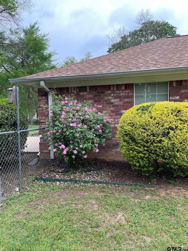 120 An County Road 4287, Palestine, TX 75803 - view of side of property with brick siding, a shingled roof, and fence