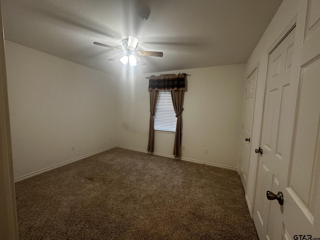 carpeted empty room with ceiling fan