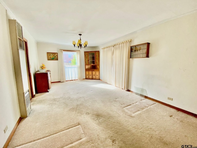 102 Gordon Dr, Crockett, TX 75835 - carpeted spare room featuring a chandelier, a heating unit, and crown molding