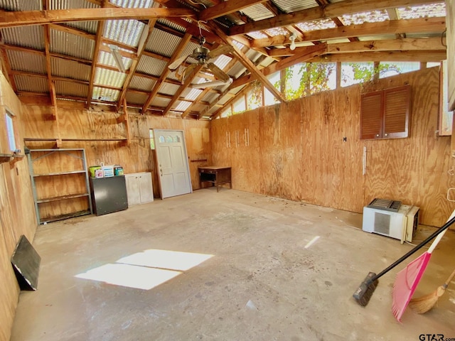 102 Gordon Dr, Crockett, TX 75835 - miscellaneous room with vaulted ceiling, wooden walls, concrete flooring, and ceiling fan
