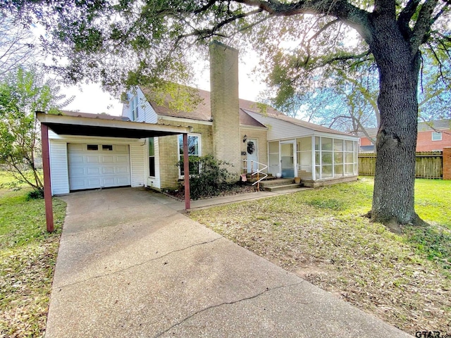 102 Gordon Dr, Crockett, TX 75835 - ranch-style home with a chimney, driveway, and a sunroom