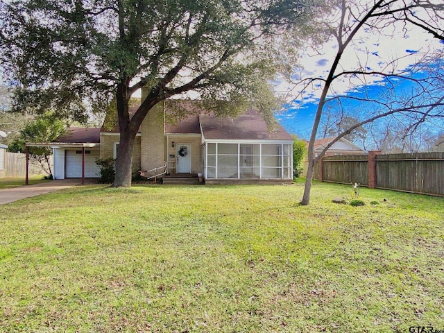 102 Gordon Dr, Crockett, TX 75835 - view of front of house featuring a sunroom, driveway, and an attached garage